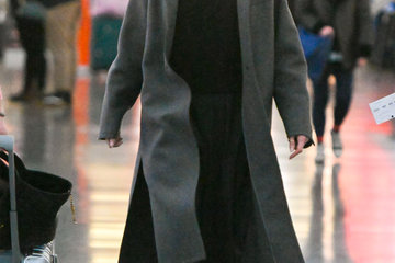 Angelina Jolie nails airport style in black trench coat