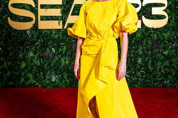 Gwyneth Paltrow wore a yellow shirred puff sleeve sarong gown from